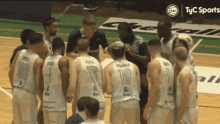 a group of basketball players are huddled together and one of them has the number 12 on their back