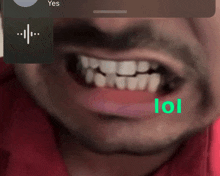 a close up of a man 's mouth with the word lol written in green