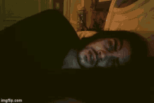 a man with a beard is laying on a bed with imgflip.com written on the bottom right