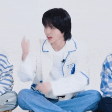 a person sitting on the floor with their legs crossed and pointing upwards