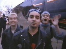 a group of young men are standing in front of a van