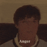 a close up of a man 's face with the word anger on the bottom