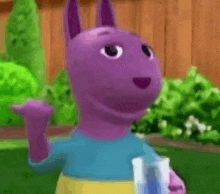 a purple cartoon character from backyardigans is standing in front of a wooden fence holding a book .