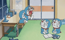 three doraemons are sitting in a room with a desk and chair