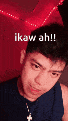 a man wearing a cross necklace says ikaw ah !!
