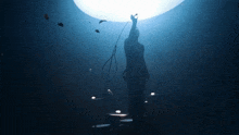 a person holding a microphone in front of a large light