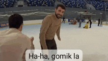 a man is standing on a ice rink with the words ha-ha gomik la on the bottom