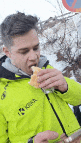 a man wearing a yellow jacket with krka written on it