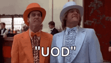 two men in suits and hats are standing next to each other in a room and saying uod .