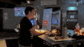 a man is sitting at a desk in front of a computer monitor ..