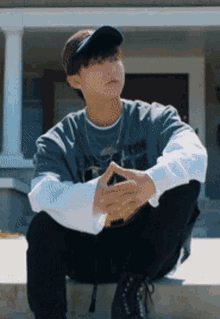 a young man wearing a baseball cap and a t-shirt that says ' i love you ' on it