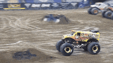 a monster truck that looks like a school bus is on a dirt track