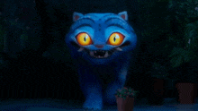 a blue cat with orange eyes is standing in the dark .