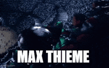 a crowd of people screaming in a stadium with the words max thieme in white letters .