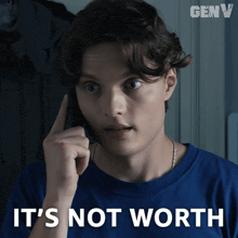 a man in a blue shirt talking on a cell phone with the words it 's not worth above him