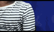 a man is wearing a black and white striped shirt .
