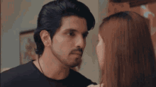 a man and woman are looking at each other