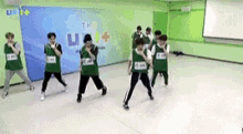 a group of young people are dancing in a room .
