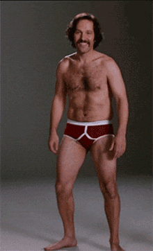 a shirtless man with a mustache and red underwear