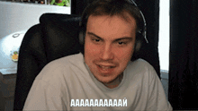 a man wearing headphones and a white shirt says aa aa aa aa aa aa