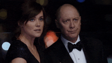 a man in a tuxedo and a woman in a black dress are standing next to each other with clear the ad written in red