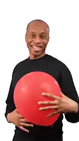 a man in a black shirt is holding a large red balloon
