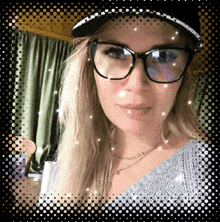 a woman wearing glasses and a hat is taking a picture of herself