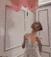 a woman wrapped in a towel is standing in a bathroom