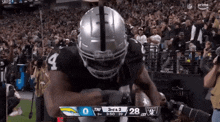 a football player wearing a helmet with the number 4 on it is running with the ball