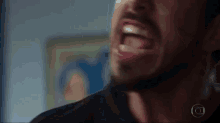 a close up of a man 's face with his mouth wide open