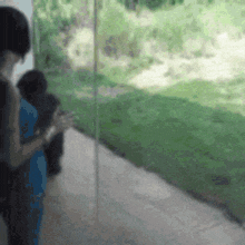 a blurred image of a person standing in front of a glass wall