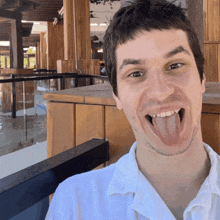 a man sticking his tongue out while looking at the camera