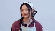 a woman wearing an apron and a head scarf with strawberries on it