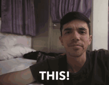 a man laying on a bed with the words this written on his face