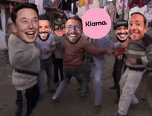 a group of men are posing for a photo with a pink circle that says klarna on it