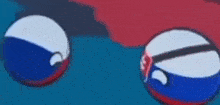 three balls with different flags on them are floating in the air on a blue background .
