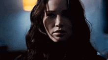 a close up of a woman 's face with long dark hair