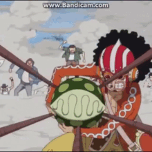 a man in a red and white helmet is holding a watermelon in his hands ..