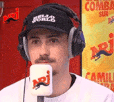 a man wearing headphones and a hat that says " hello world "