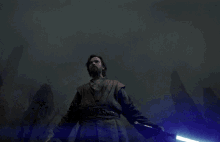 a man holding a blue light saber in his hand