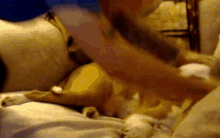 a man with a tattoo on his arm is laying on a bed with a woman