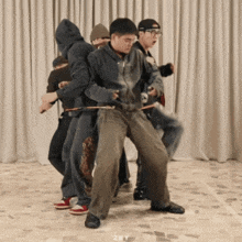 a group of people are dancing together and the word zmy is above them