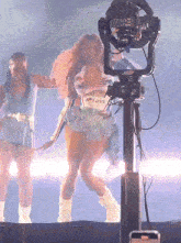 a woman wearing a shirt that says " i love " is dancing on stage