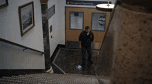 a man is walking down a set of stairs towards the emergency department