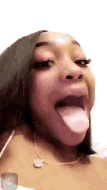 a woman is sticking her tongue out in a video call .