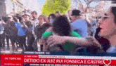 a crowd of people are gathered in front of a tv screen that says sic noticias