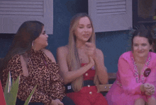 three women are sitting on a bench and one of them has a name tag that says jenny on it