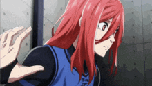 a girl with red hair is wearing a blue shirt that says team on it