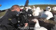 a man taking a picture of turkeys with the words turkey sounds