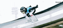 a person wearing a helmet that says ' supreme ' on it is skiing down a track